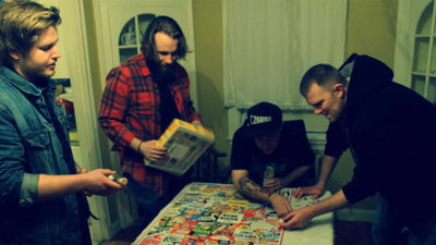 Cold Collective band promo photo, band members putting a puzzle together