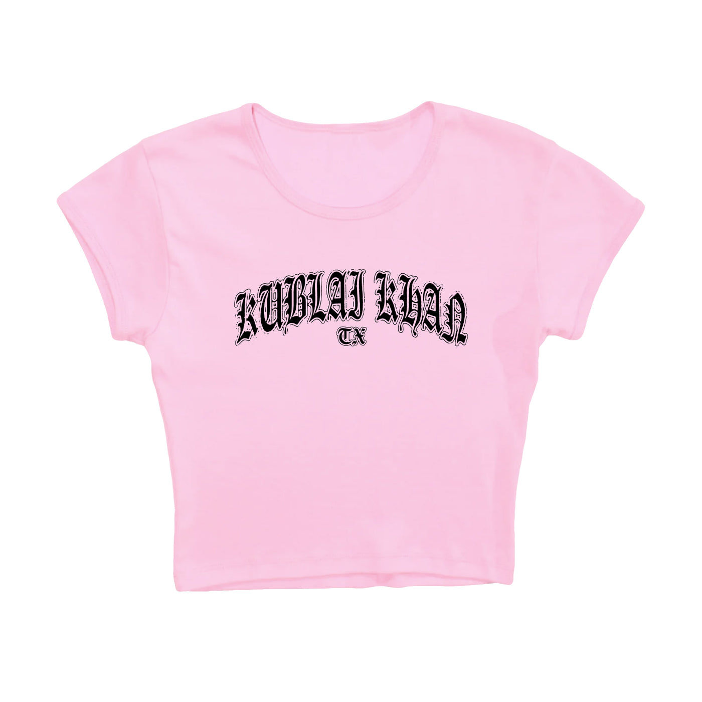 A light pink cropped t-shirt by Kublai Khan TX, featuring bold black Gothic lettering on the front. This presale item ships starting 10/17/25.