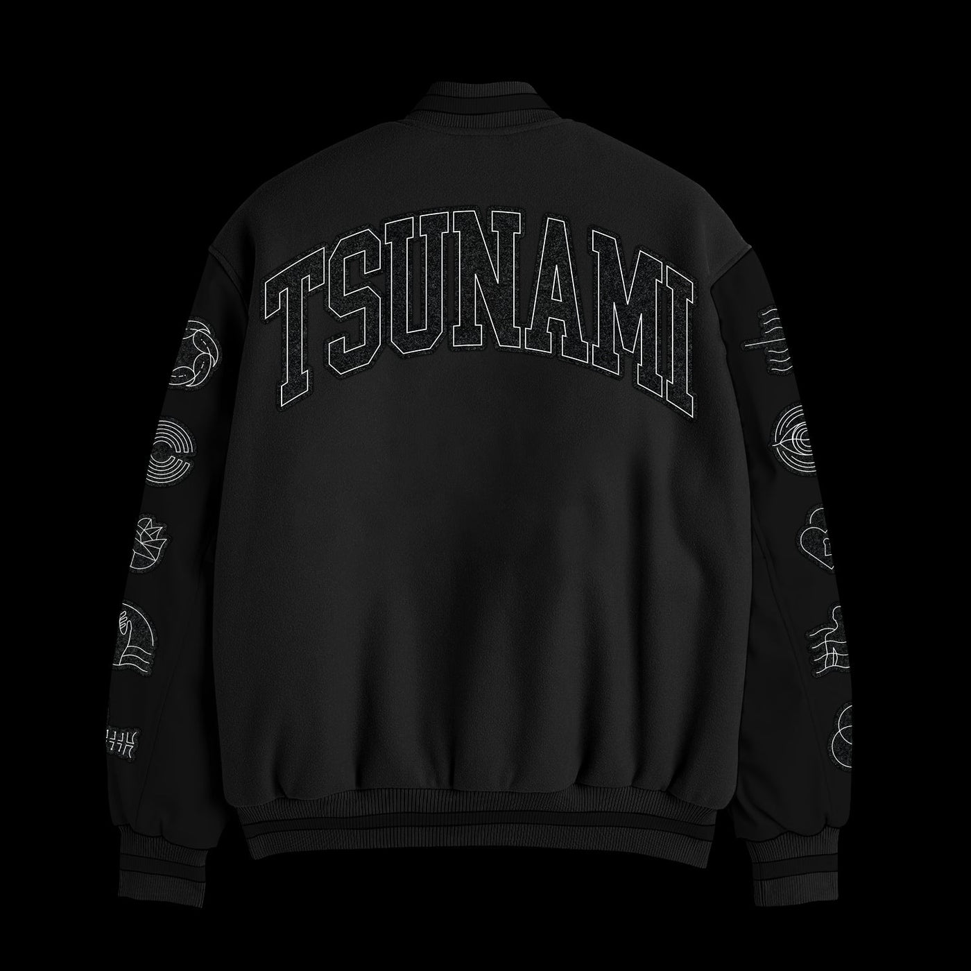 A black Spiritbox custom-made varsity jacket with TSUNAMI in bold block letters on the back and white chenille wave embroidery on both sleeves, shown against a solid black background.