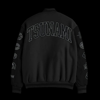 A black Spiritbox custom-made varsity jacket with TSUNAMI in bold block letters on the back and white chenille wave embroidery on both sleeves, shown against a solid black background.