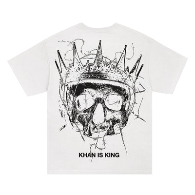 Kublai Khan TX presale: Comfort Colors white tee with a bold black skull in a spiked crown on the back and "KHAN IS KING" text below.
