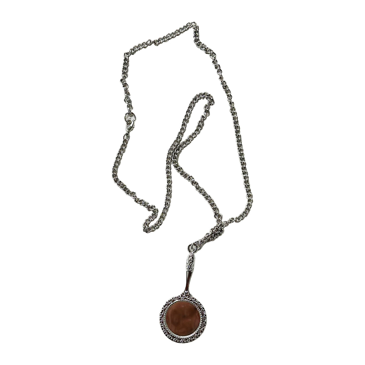 A PVRIS silver chain necklace features a circular brown pendant bordered by decorative silver, creating an elegant jewelry piece displayed on a white background.