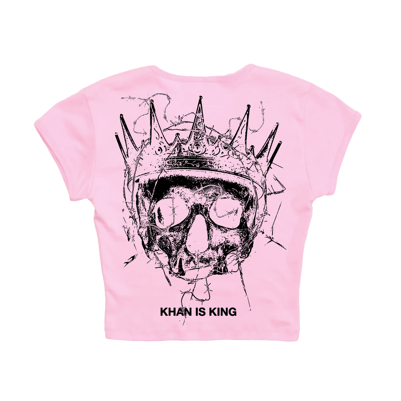 Light pink Kublai Khan TX 1010 cropped t-shirt with a black crowned skull and “KHAN IS KING” text. Available for presale now; shipping begins 10/17/25.